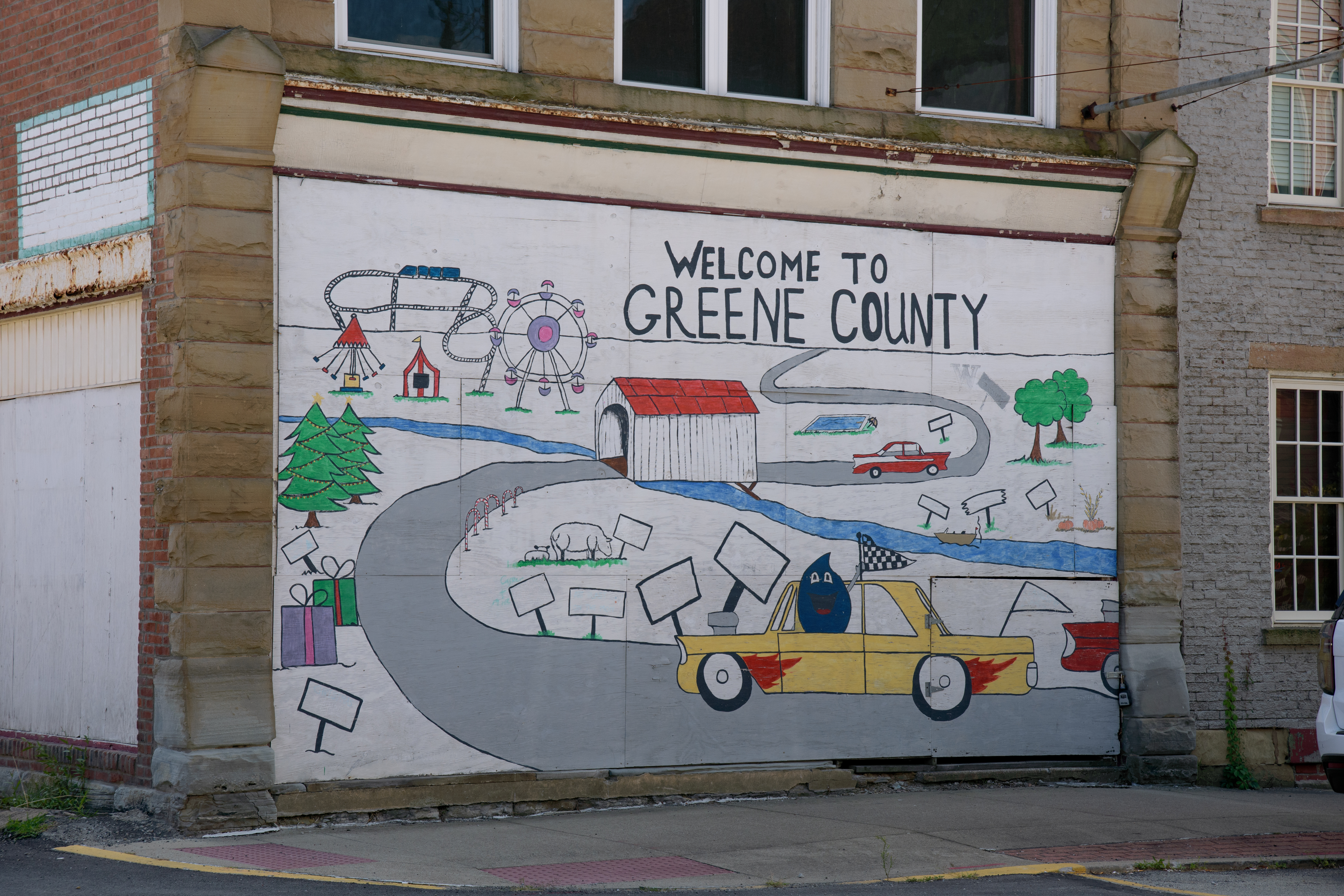 A mural in Waynesburg, PA reads “Welcome to Greene County.”